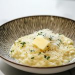 Italian Risotto, served in a deep plate with parmesan and butter.