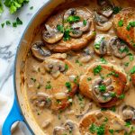 Italian Veal Marsala With mushrooms served in a blue pot.
