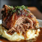 German Pork Knuckle, served on a white plate.