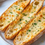 Homemade Garlic Bread served on a white plate.