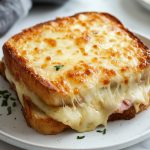 Croque Monsieur, served on a white plate.