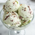 Pistachio Stracciatella Gelato, served in a glass dish.