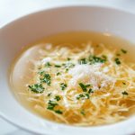 Stracciatella Soup, served in a bowl.