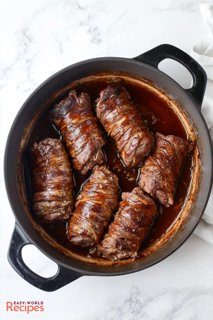 Beef Braciole (Involtini), in a large pot.