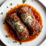 Traditional Italian Braciole al Sugo, served on a plate.