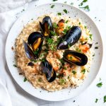Risotto ai Frutti di Mare - Italian Seafood Risotto, served in a white plate.