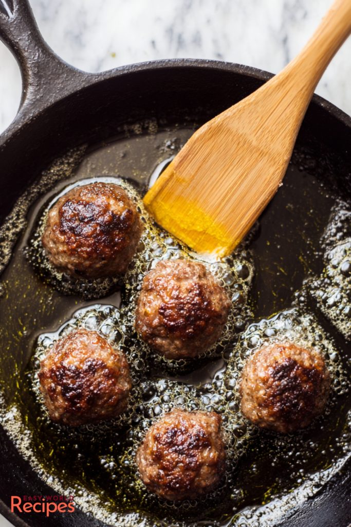 Frying Greek Keftedes on a pan.