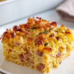 Czech Šunkofleky - A pasta casserole on a white plate.