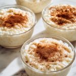 Greek Rizogalo, topped with fresh cinamon, served in bowls.