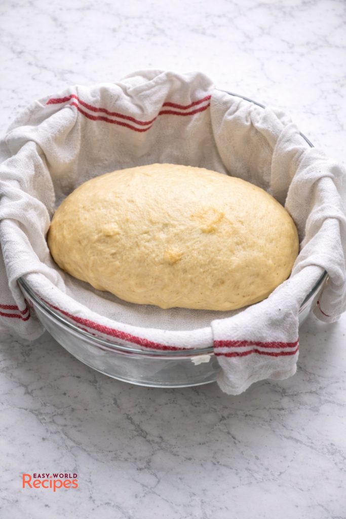 Czech Bread Dumplings Knedlíky, in a large bowl, lined with a towel.