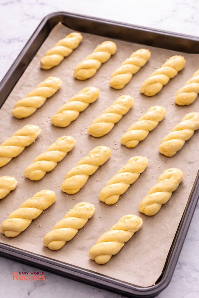 Unbaked Koulourakia on a baking dish